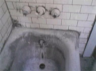 mold and scum in a tub and wall enclosure 