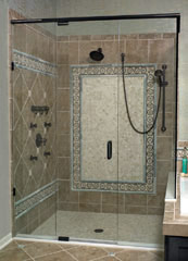 frameless pivoting shower door with a handheld shower and rain head 