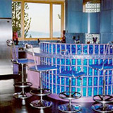 Glass block bar with blue colored decora pattern glass blocks in a 4in x 8in size in a rounded radius design in New York City.