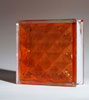 glass block in topaz orange color with a diamond pattern