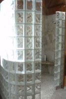 tile shower with a no barrier entrance with glass block walls 