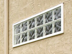 vinyl framed glass block window in a stucco wall 