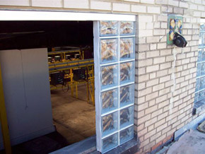 industrial glass block window installation in process being put in aluminum channel