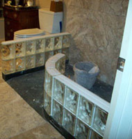 premade glass block shower walls during the construction process 