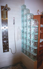 step down half wall in bath and shower space using colored glass blocks 