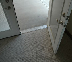 Low threshold front door and lever handle for a universal design front entrance 
