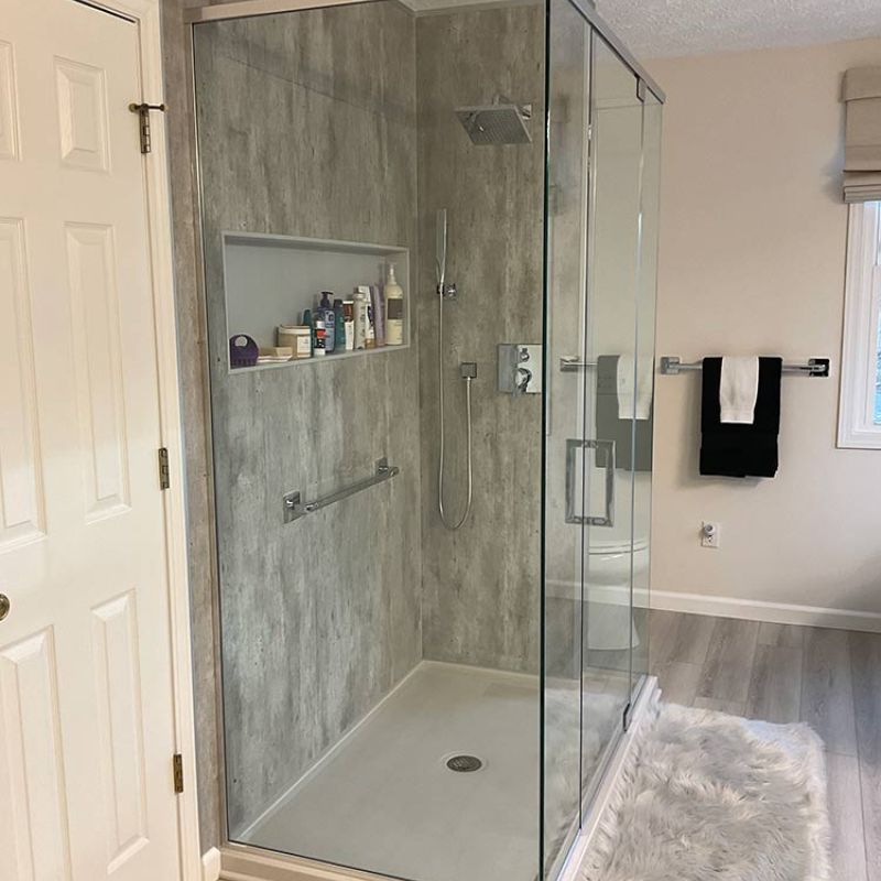 AFTER - concrete wall panels with new shower base and glass enclosure