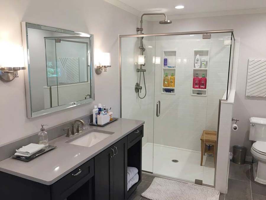 Age in place shower with solid surface shower pan and a pivoting glass door - The Bath Doctor Mayfield Heights Ohio 