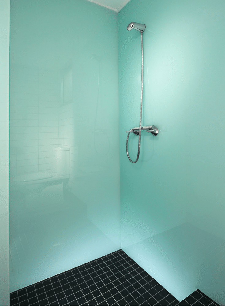 Glacier colored high gloss wall panels with a black tile floor pan | Innovate Building Solutions | Innovate Builders blog  | #HighGloss #GlacierColor #BlueShower #WallPanels