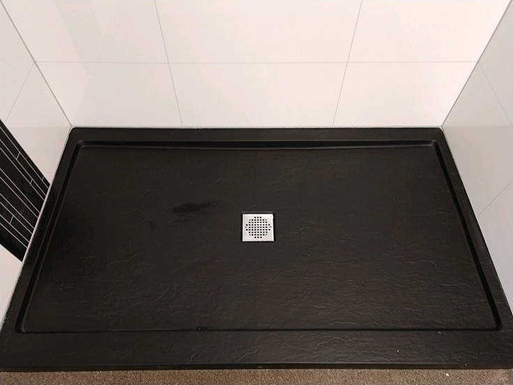 Laminate shower panels with low profile textured black shower pan | Innovate Building Solutions | Innovate Builders Blog | #Texturedshowerbase #ShowerBase #lowprofileshower 