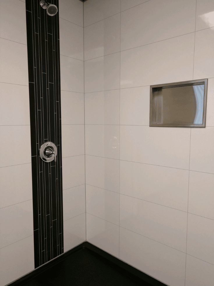 Stainless steel recessed niche in laminate shower wall panels | Innovate Builders Blog | Innovate Building Solutions | #Laminatewallpanels #StainlessSteel #RecessedNiche