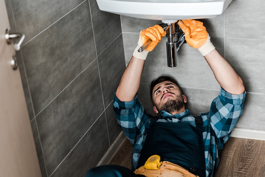 contractor repairing a leak smaller jobs | Innovate Building Solutions | innovate builders blog | #Contractor #RepairSink #plumbingrepair