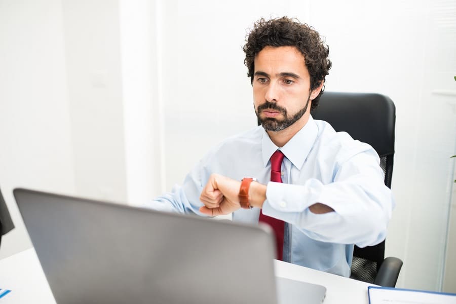 Impatient businessman snorting while watching his watch | Innovate Building Solutions #RemodelingProject #RemodelingDesign #BathroomDesign