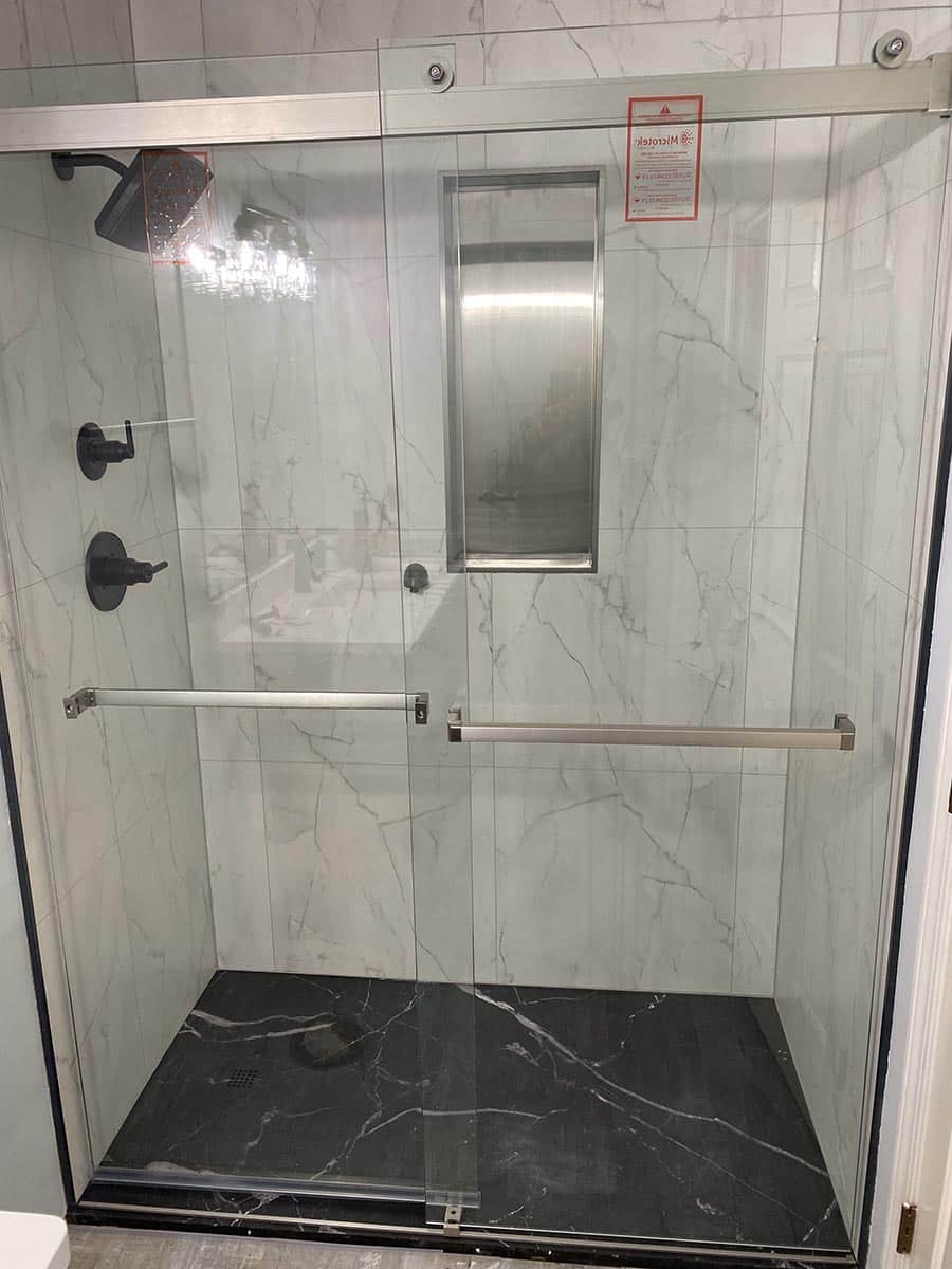 Reason 7 InnovaStone Black Marble stone low profile shower pan with Bianco marble wall panels | Innovate Building Solutions | black marble base | home design ideas | bathroom remodeling tips | bathroom remodeling shower base