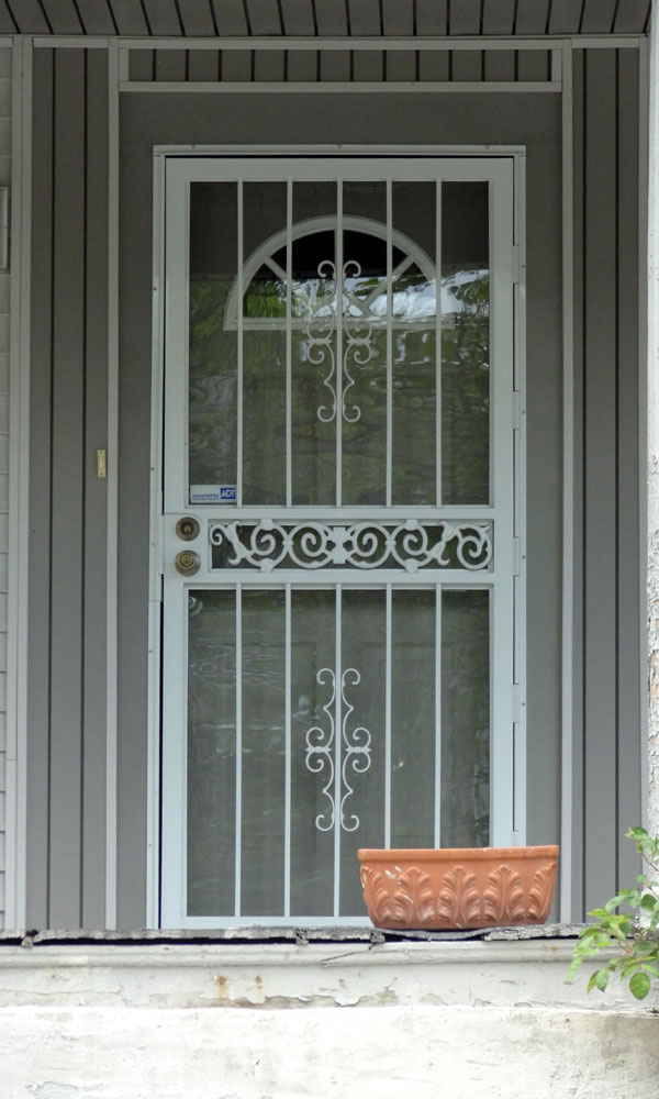 Mail slot for storm door