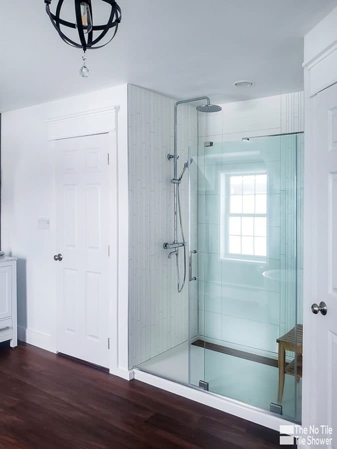 white faux tile laminate shower panels vertical stripe in a short term rental vacation bathroom | Innovate Building Solutions | Multi Unit | Luxury Apartments | #HotelBathrooms #LuxuryBathrooms #LuxuryAirBNB