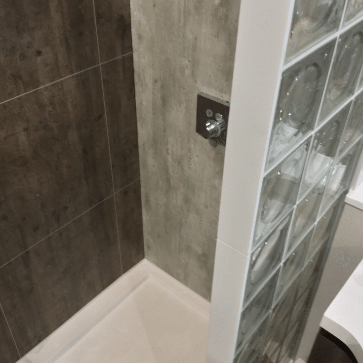 Contrasting patterns of laminate wall panels and contemporary acrylic shower pan | Innovate Building Solutions | Multi Unit | Modular Homes | #Laminatewallpanels #AcrylicShowerPan #ShowerBase 