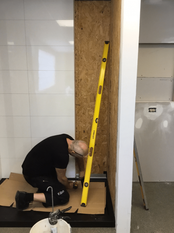 Laminate shower panels being installed in a modular home | Innovate Building Solutions | Multi Unit | Modular Homes | #LaminateWallPanels #ShowerWallPanels #ModularHomes 