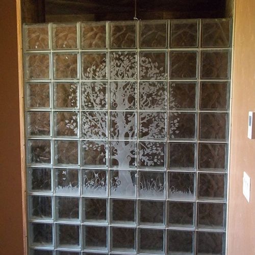 Etched tree mural in a wave pattern glass block shower - Innovate Building Solutions 
