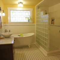 Step down glass block wall and patterned and yellow color glass block bathroom window in a vintage bathroom in Texas - Innovate Building Solutions 
