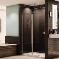 Semi-frameless pivoting shower shield for a curbed base or wet room - Innovate Building Solutions 
