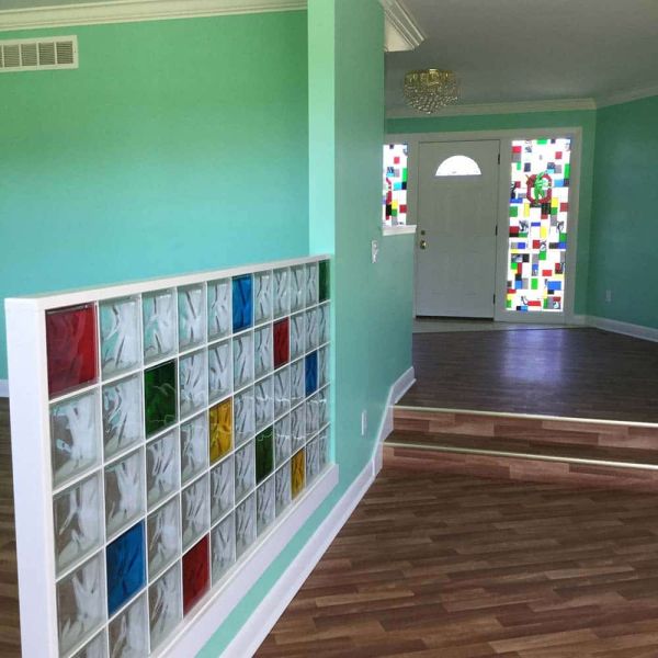 Multi color glass blocks (red blue green yellow) in a family room partition wall  - Innovate Building Solutions 