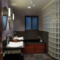Transitional bathroom with a glass block wall and black soaking tub - Innovate Building Solutions Columbus Ohio 