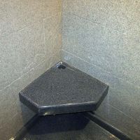 Angled durable corner seat in a solid surface shower - Innovate Building Solutions 