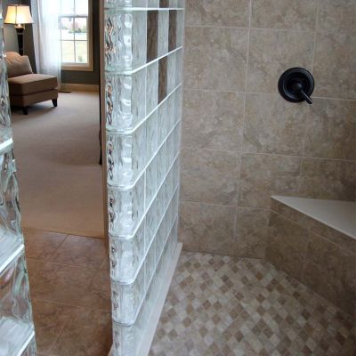 Bench seat in a 2 sided glass block walk in shower wall design