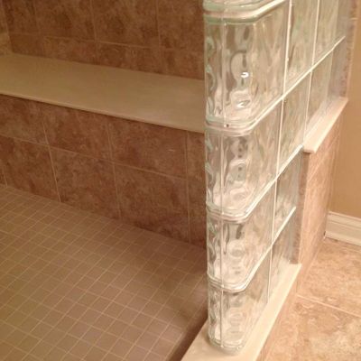 Bench seat in a step down tile glass block shower