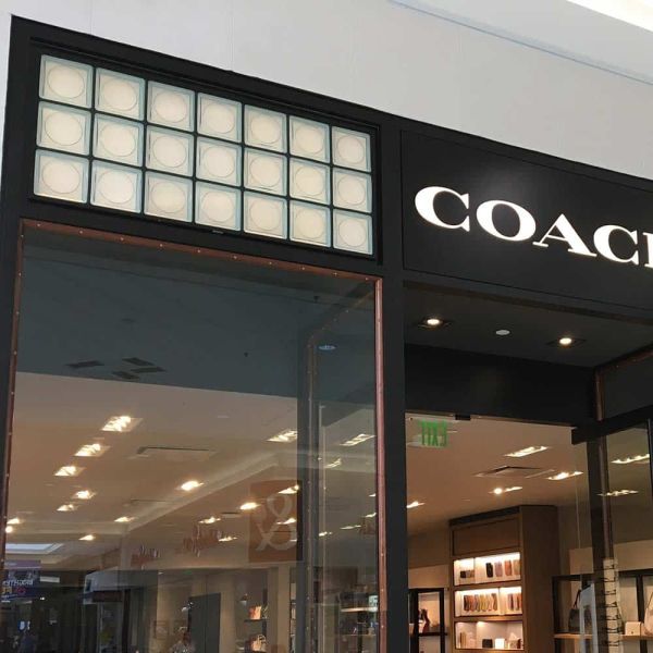 Circular focus glass block pattern in a Coach retail store - Innovate Building Solutions 