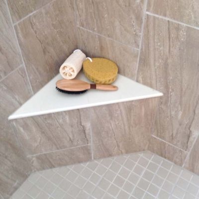 Corner bench seat in a glass block tile shower