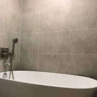 Grey Sahara 24 x 16 bathroom wall panels with a stand alone tub