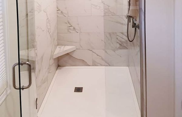 Custom sized solid surface cultured granite shower pan with a pivoting glass door Cleveland Ohio 