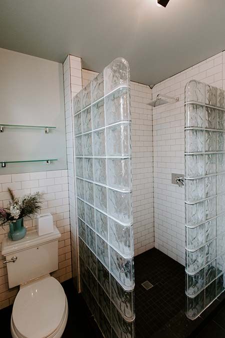Prefabricated glass block shower with brown colored glass blocks on a marble base - Innovate Building Solutions 