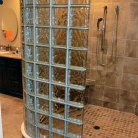 Open roll in one level shower with a glass block 90 degree curved wall set  on a curb cap - Innovate Building Solutions  in Simi Valley California 