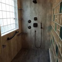 Ice pattern high privacy glass block shower window with a multi-colored glass block wall and grout free laminate wall panels - Innovate Building Solutions 