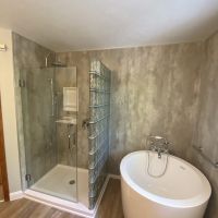 Glass Block Shower With Free Standing Tub & Cracked Cement Wall Panels