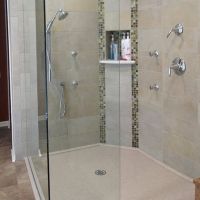 Custom solid surface shower pan with a clipped corner in a low profile design with tile walls 