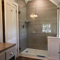 Marina gray oak laminate shower wall panels with pivoting frameless shower doors - The Bath Doctor Cleveland Ohio 