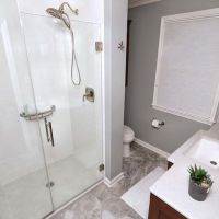 Low profile shower with solid surface wall panels in a Broadview Heights bathroom renovation 
