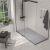 Matte gray stone shower pan and glass enclosure