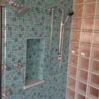 Herringbone mosaic tile niche pattern with a glass block wall - Innovate Building Solutions 