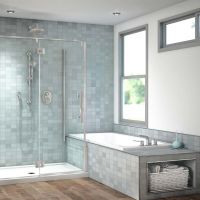Pivoting shower door over a raised tub deck in a modern bathroom - The Bath Doctor 