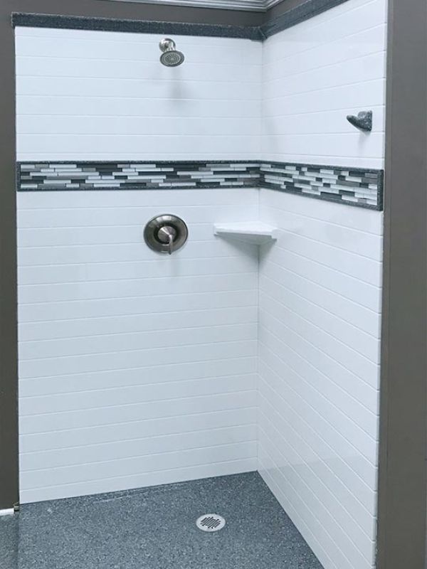 Subway tile wall panels with a decorative tile border in a Cleveland Ohio bathroom 