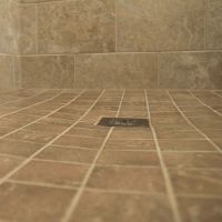 Smaller tiles in a ready for tile shower pan with a square drain - Innovate Building Solutions 