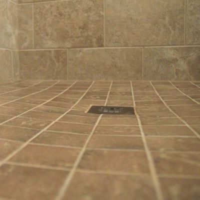 Square drain cover in a ready for tile shower pan - Innovate Building Solutions 