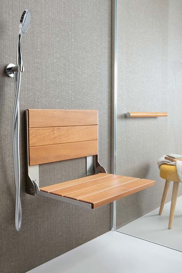 Teak fold down seat for safety in a glass block shower - Innovate Building Solutions 