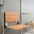 Teak fold down seat for safety in a glass block shower - Innovate Building Solutions 