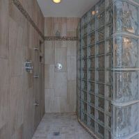 Rounded glass block shower with with a custom premade ready for tile shower pan - Innovate Building Solutions 